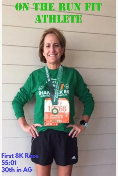 Mary with her medal after her first 8K.